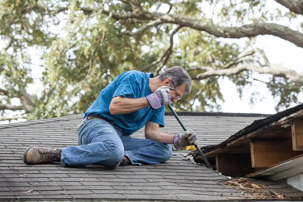 older man on roof diy